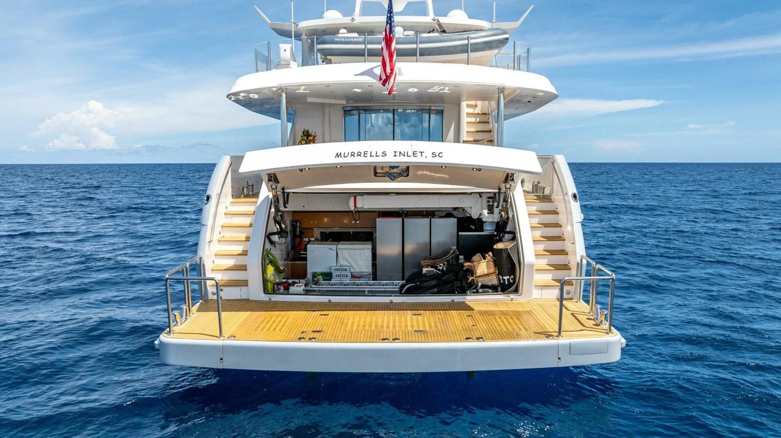 The yacht's aft deck features a spacious swim platform and an inviting open area for relaxation and water activities. aboard SHORT STORY Yacht for Sale