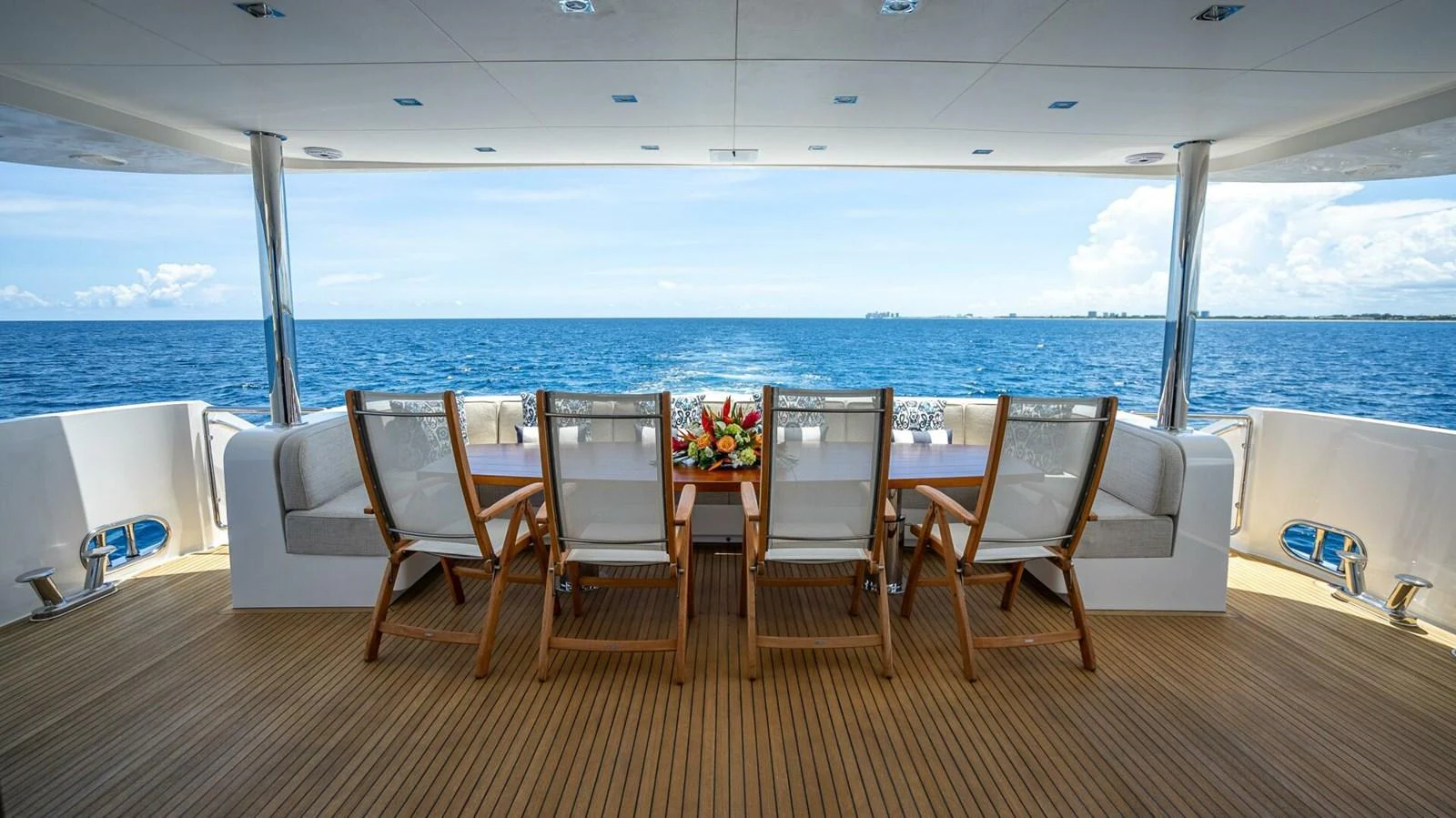 The aft deck features a spacious dining area with a stunning ocean view. aboard SHORT STORY Yacht for Sale
