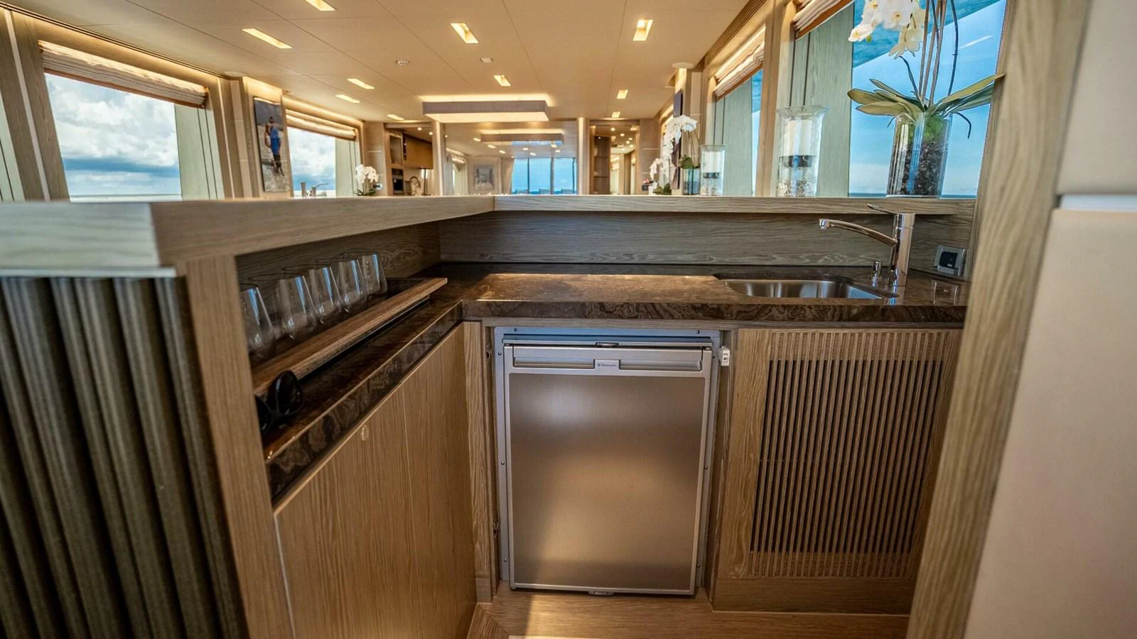 The yacht's galley features modern appliances and elegant wood finishes, creating a sophisticated and functional space. aboard SHORT STORY Yacht for Sale