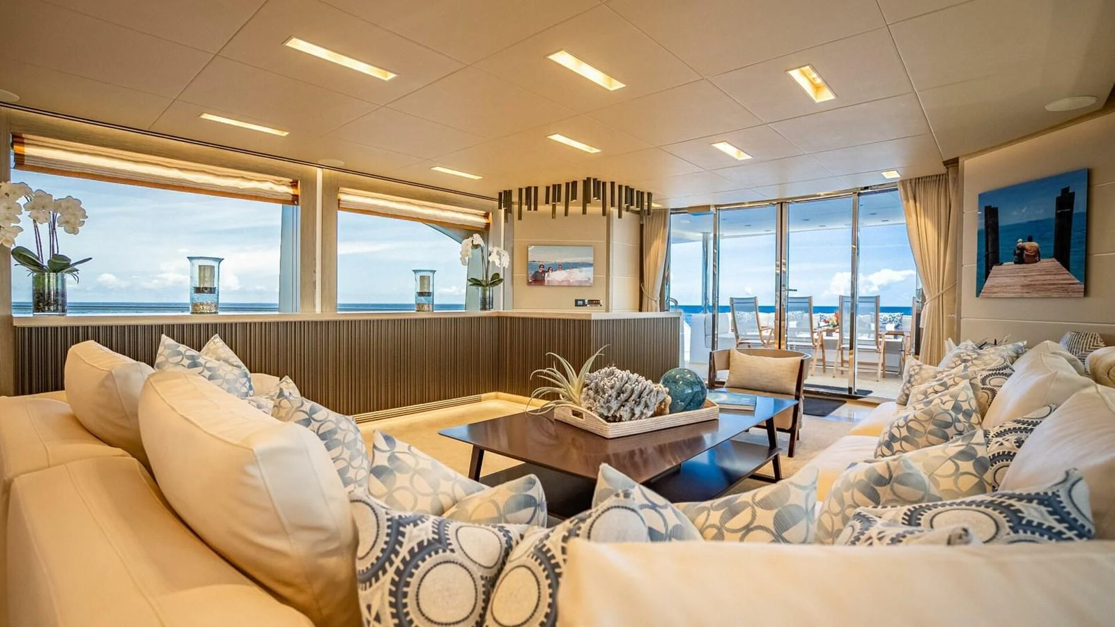 The salon offers a spacious and luxurious seating area with panoramic ocean views. aboard SHORT STORY Yacht for Sale