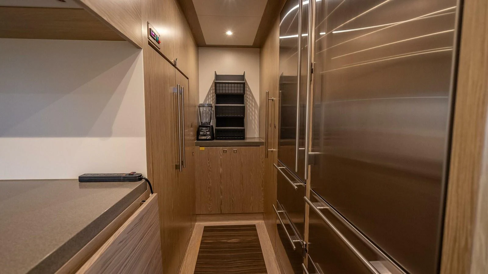 The galley features modern stainless steel appliances and ample wooden cabinetry. aboard SHORT STORY Yacht for Sale