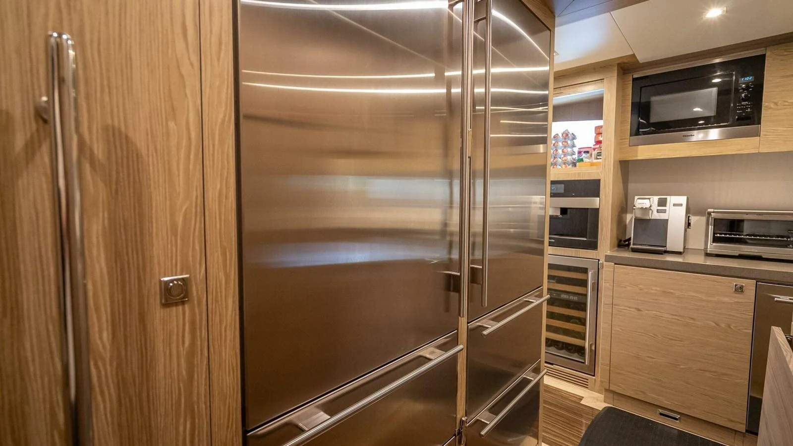 The galley features modern stainless steel appliances and ample wooden cabinetry. aboard SHORT STORY Yacht for Sale