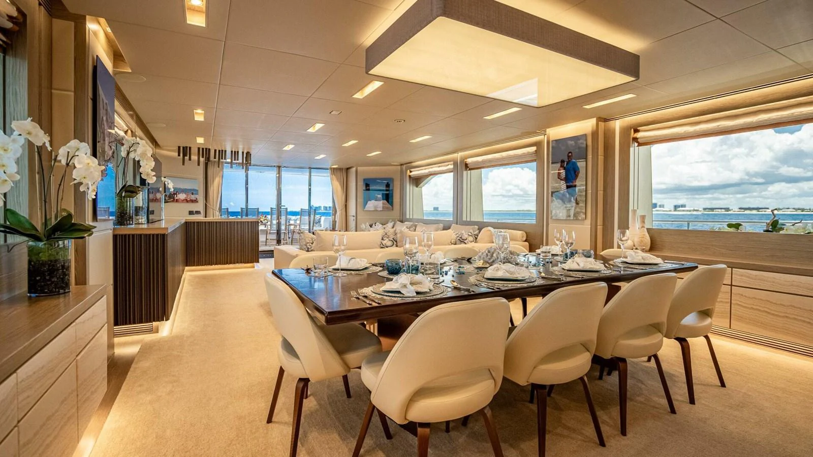 The yacht's dining area features elegant table settings and expansive windows offering stunning ocean views. aboard SHORT STORY Yacht for Sale