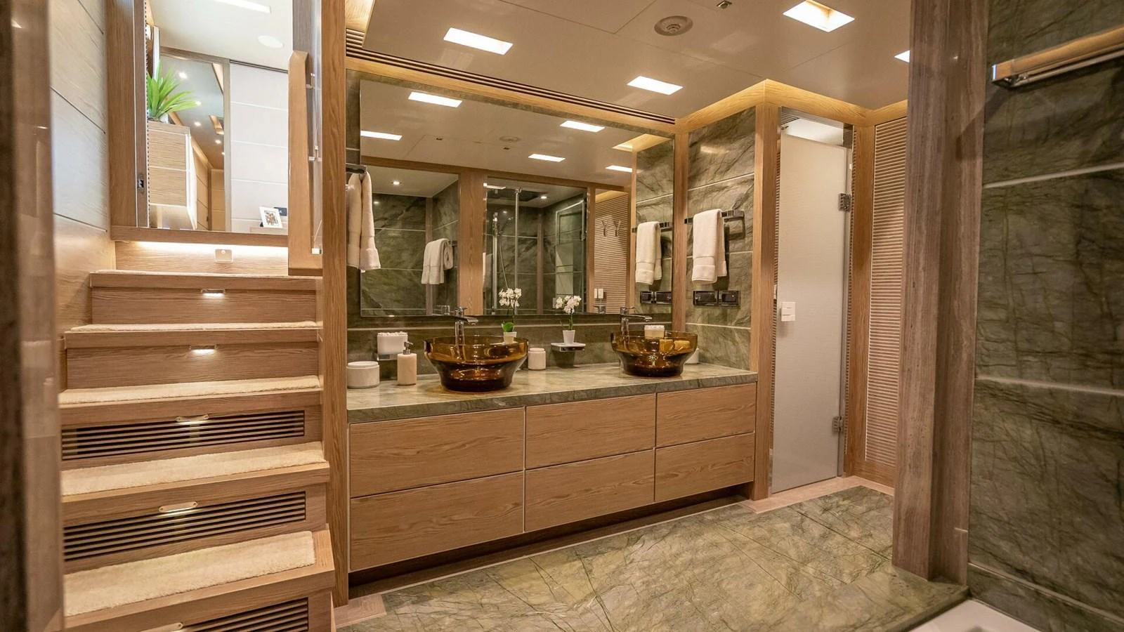 The luxurious bathroom features elegant stone finishes and modern fixtures. aboard SHORT STORY Yacht for Sale