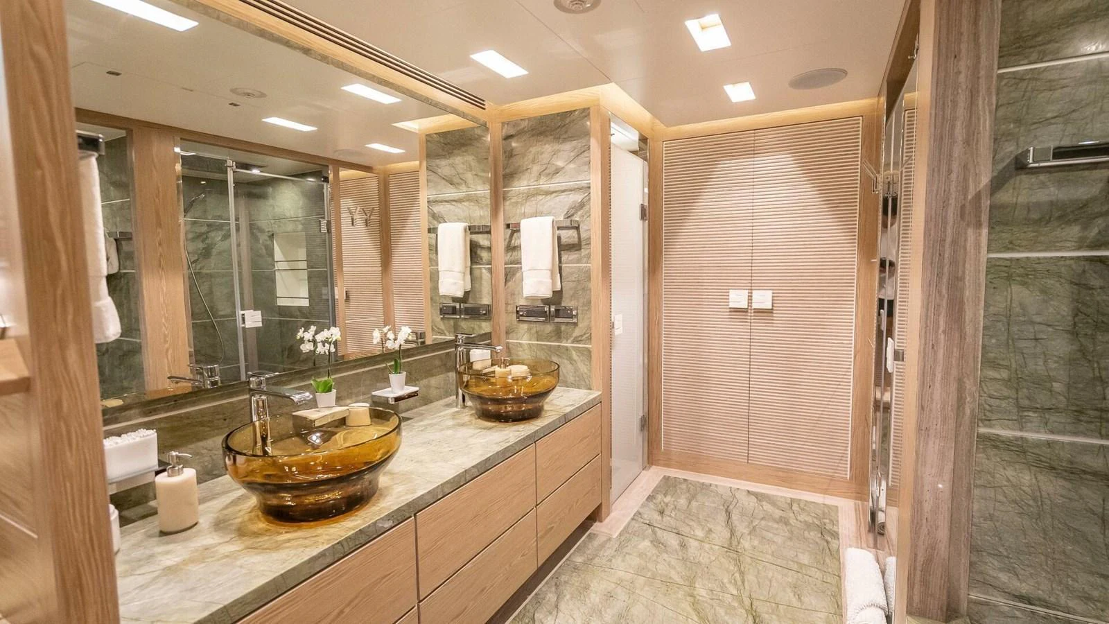 The yacht's bathroom features luxurious finishes with dual sinks and a spacious shower area. aboard SHORT STORY Yacht for Sale