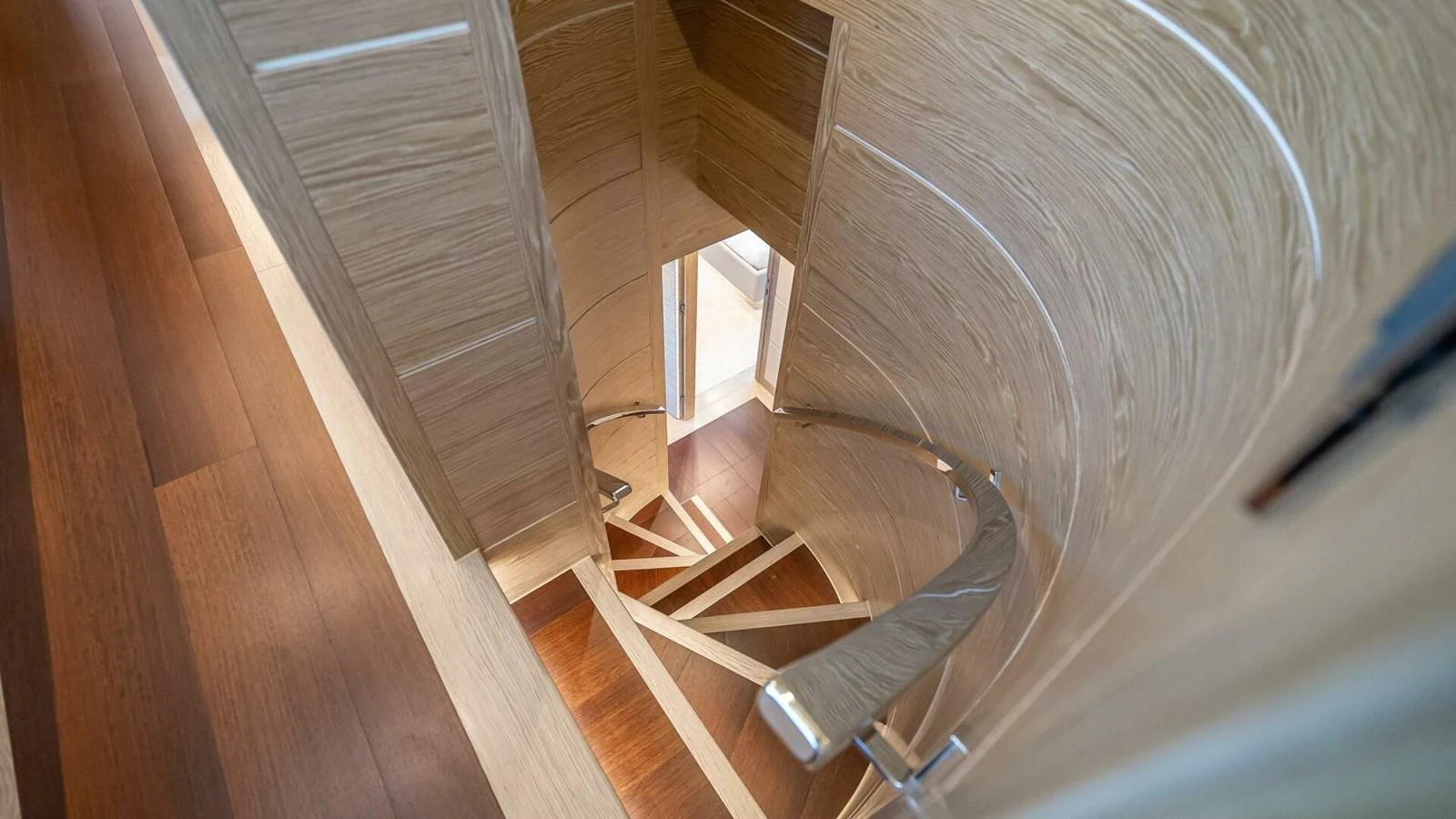A beautifully designed wooden spiral staircase connects the yacht's levels. aboard SHORT STORY Yacht for Sale