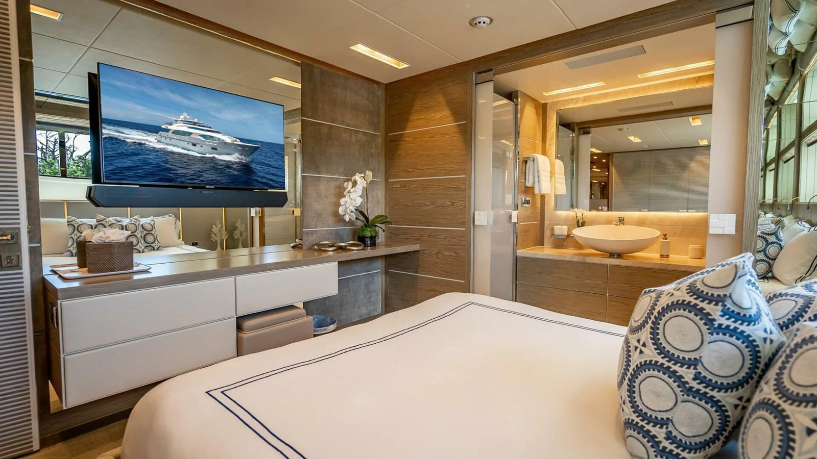 A luxurious stateroom featuring a large bed, modern decor, and an ensuite bathroom. aboard SHORT STORY Yacht for Sale