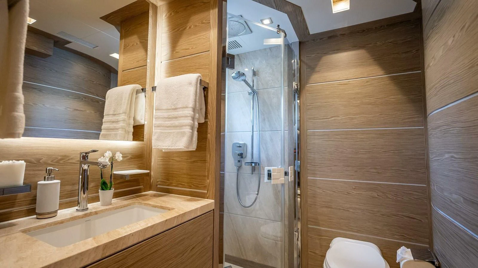 The yacht's bathroom features elegant wood paneling and modern fixtures, creating a luxurious and serene atmosphere. aboard SHORT STORY Yacht for Sale