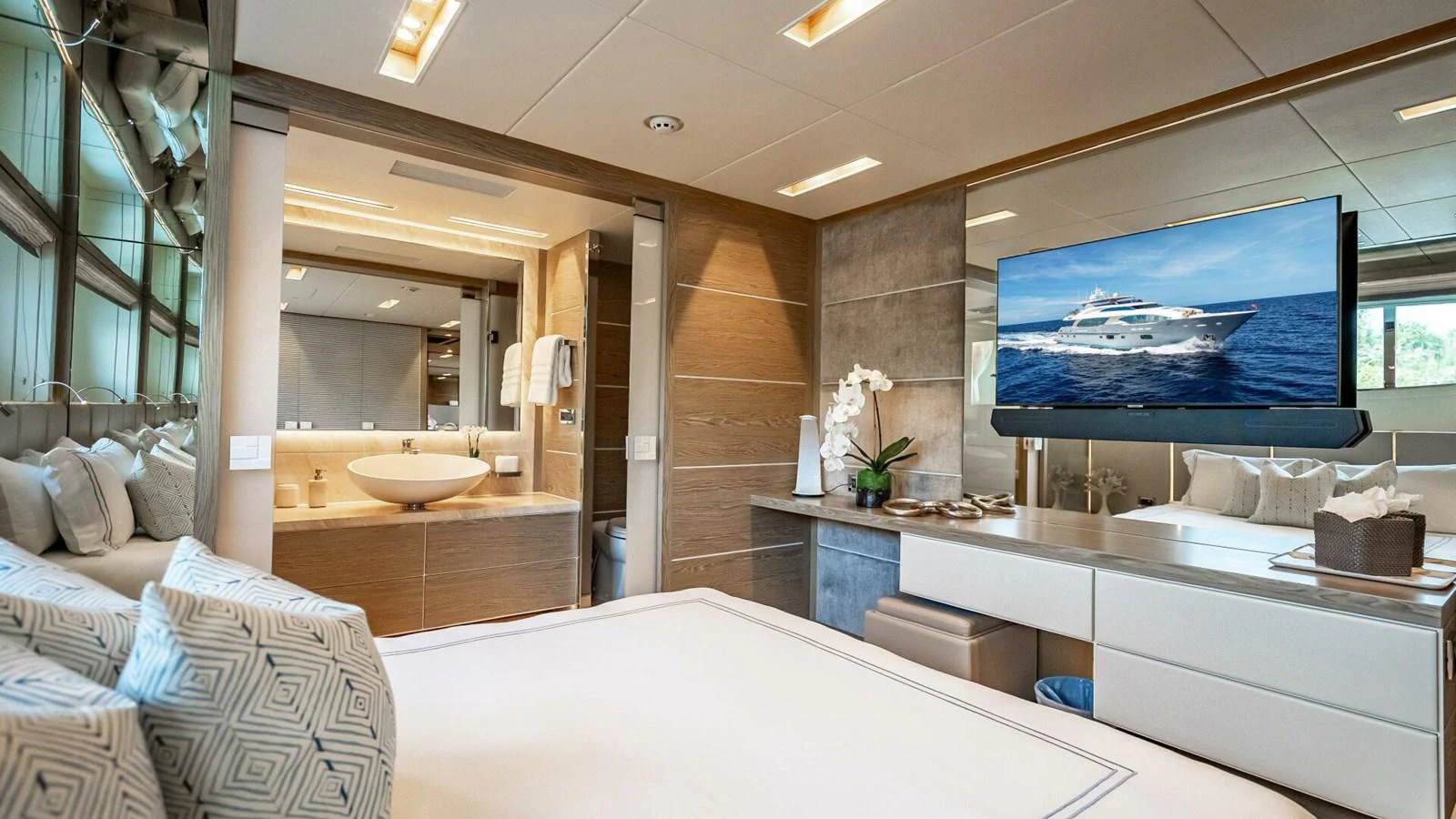 The master stateroom features a luxurious bed, modern decor, and an ensuite bathroom with elegant fixtures. aboard SHORT STORY Yacht for Sale