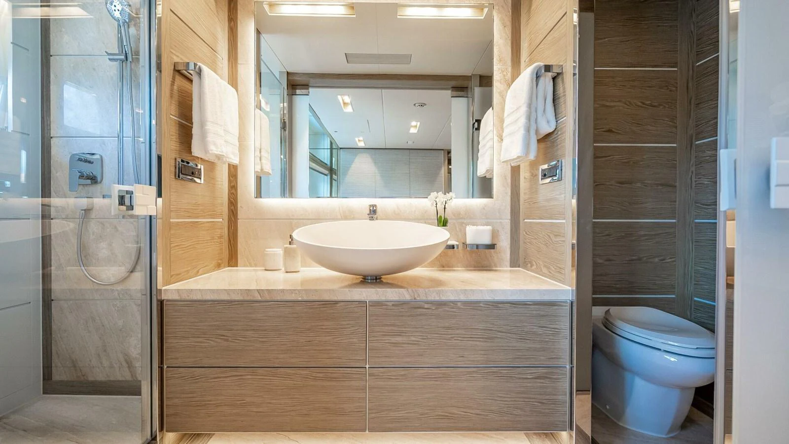 The yacht's bathroom features modern fixtures and elegant wood accents. aboard SHORT STORY Yacht for Sale