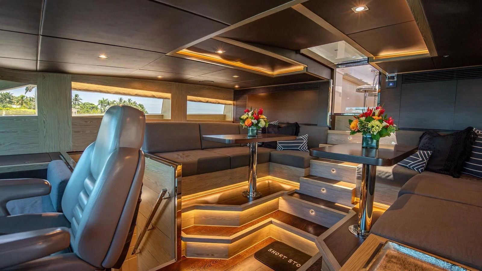 The yacht's salon features luxurious seating, ambient lighting, and elegant decor. aboard SHORT STORY Yacht for Sale