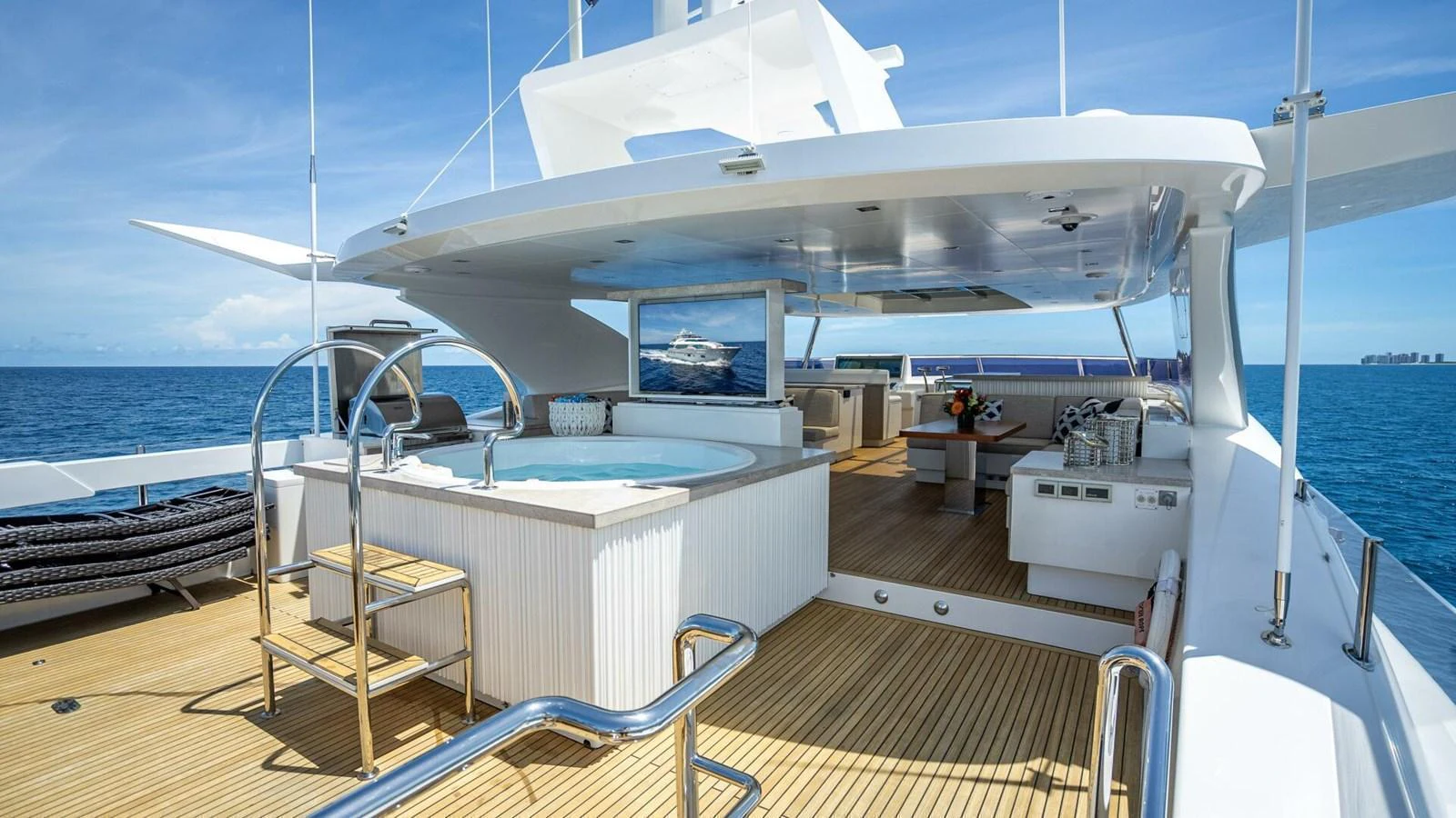 The sundeck features a luxurious hot tub and ample seating with stunning ocean views. aboard SHORT STORY Yacht for Sale