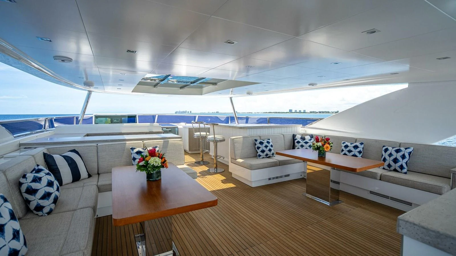 The aft deck features spacious seating with elegant decor and a stunning ocean view. aboard SHORT STORY Yacht for Sale