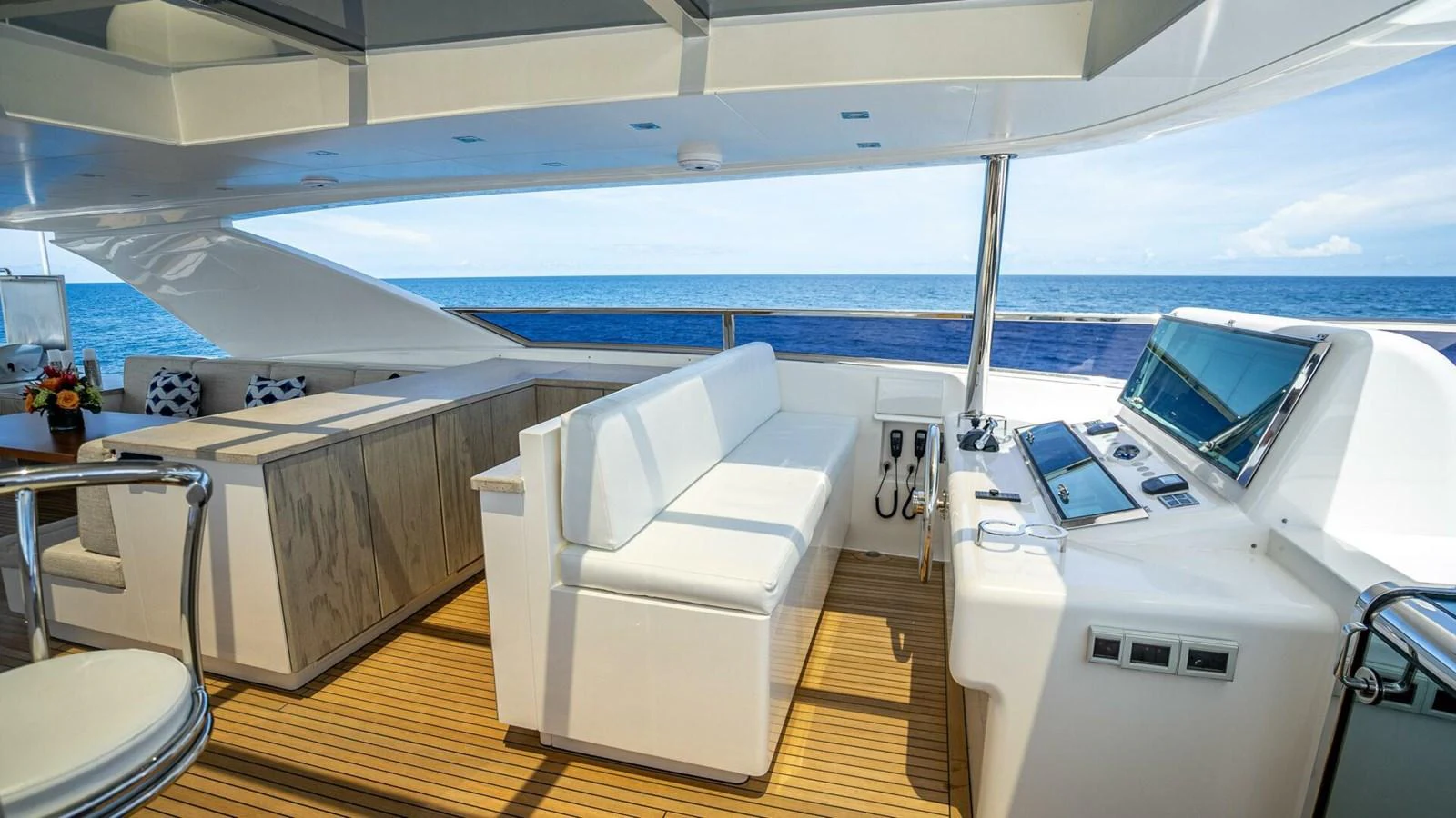 The flybridge offers a spacious and luxurious area for relaxation and navigation with stunning ocean views. aboard SHORT STORY Yacht for Sale
