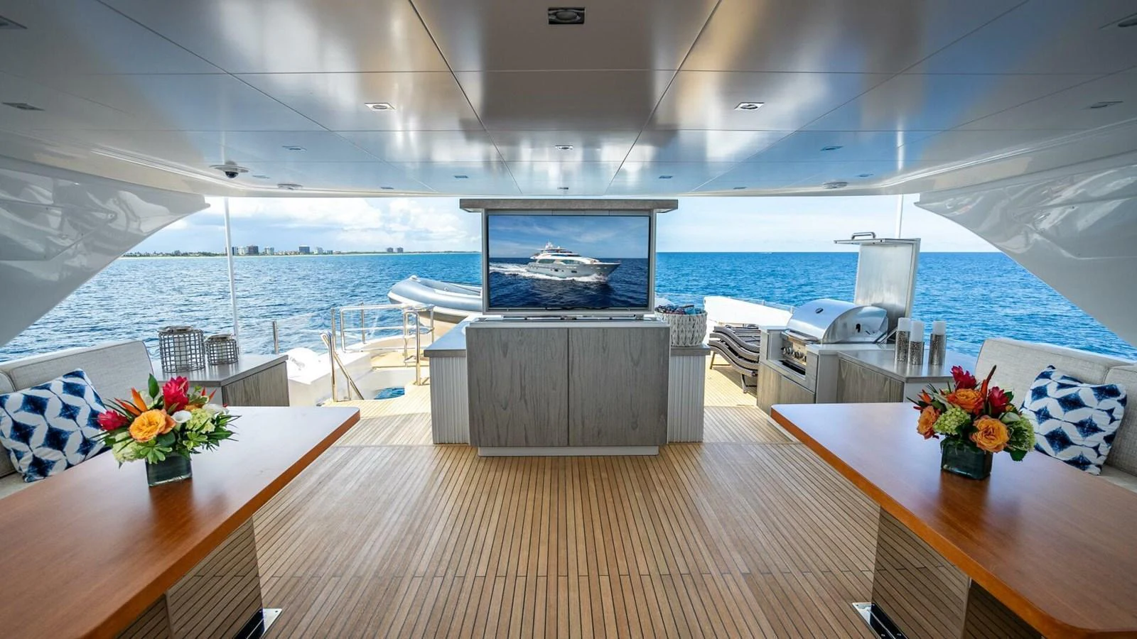 The aft deck features a spacious seating area with a stunning ocean view, perfect for relaxation and entertainment. aboard SHORT STORY Yacht for Sale