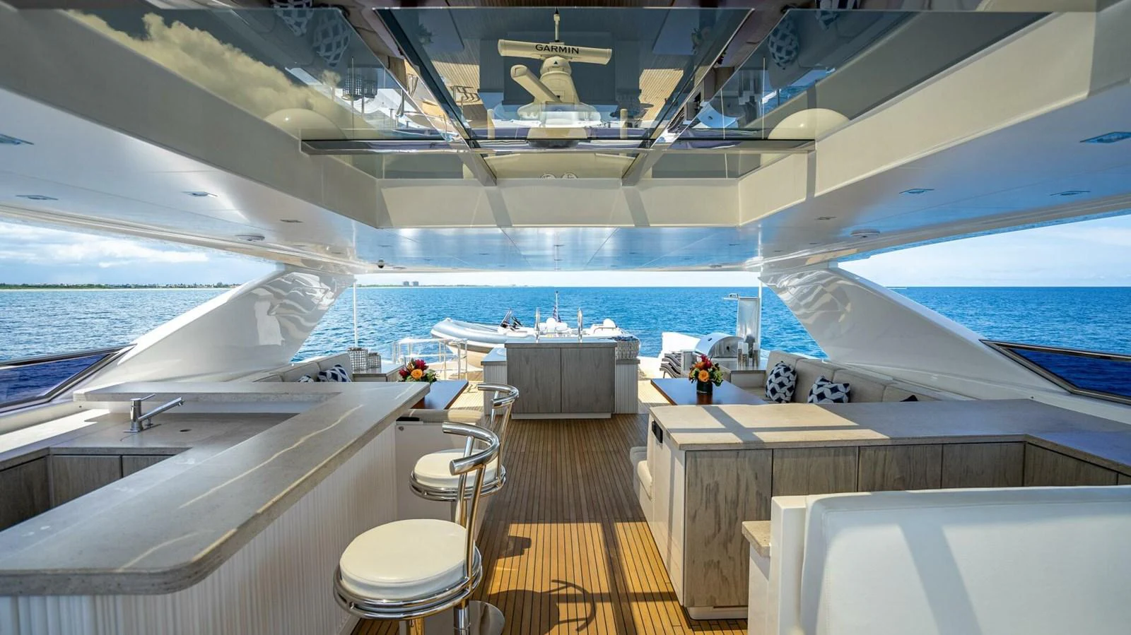 The flybridge offers a luxurious open-air space with a bar, seating, and stunning ocean views. aboard SHORT STORY Yacht for Sale