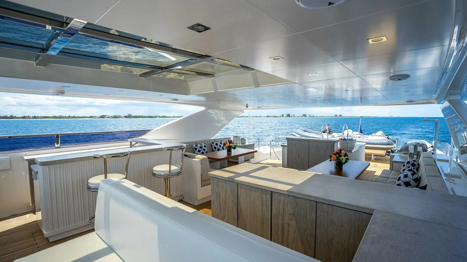 The aft deck offers a spacious and elegant area for relaxation and dining with stunning ocean views. aboard SHORT STORY Yacht for Sale
