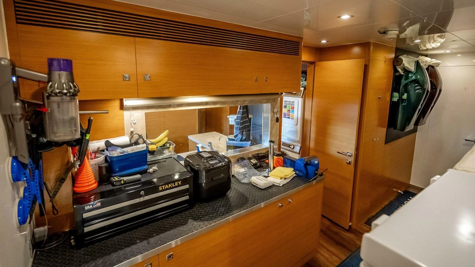 The image shows a well-organized utility or workshop area inside the yacht, featuring various tools and equipment. aboard SHORT STORY Yacht for Sale