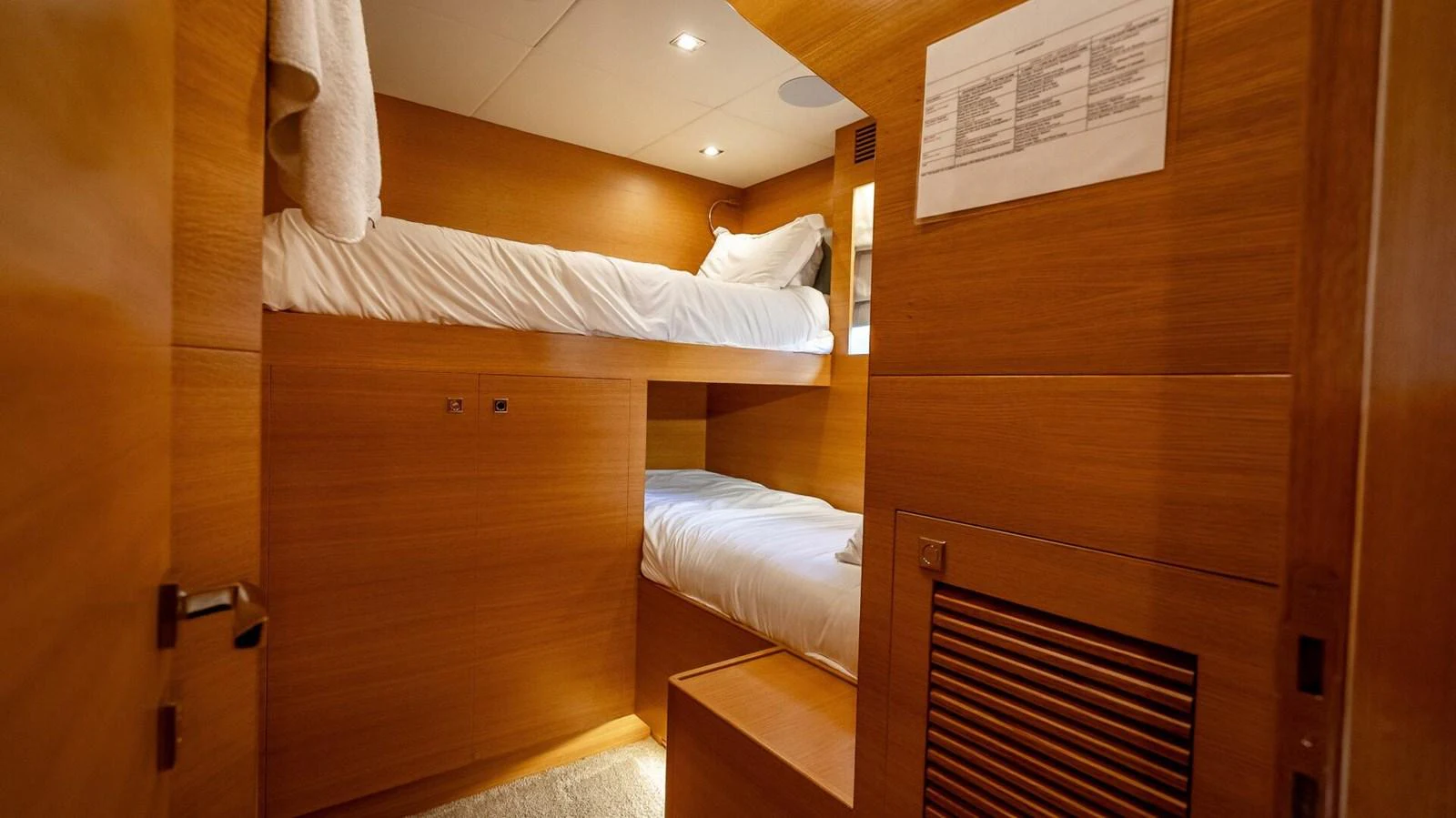 A cozy cabin with wooden finishes and bunk beds, perfect for a comfortable stay. aboard SHORT STORY Yacht for Sale