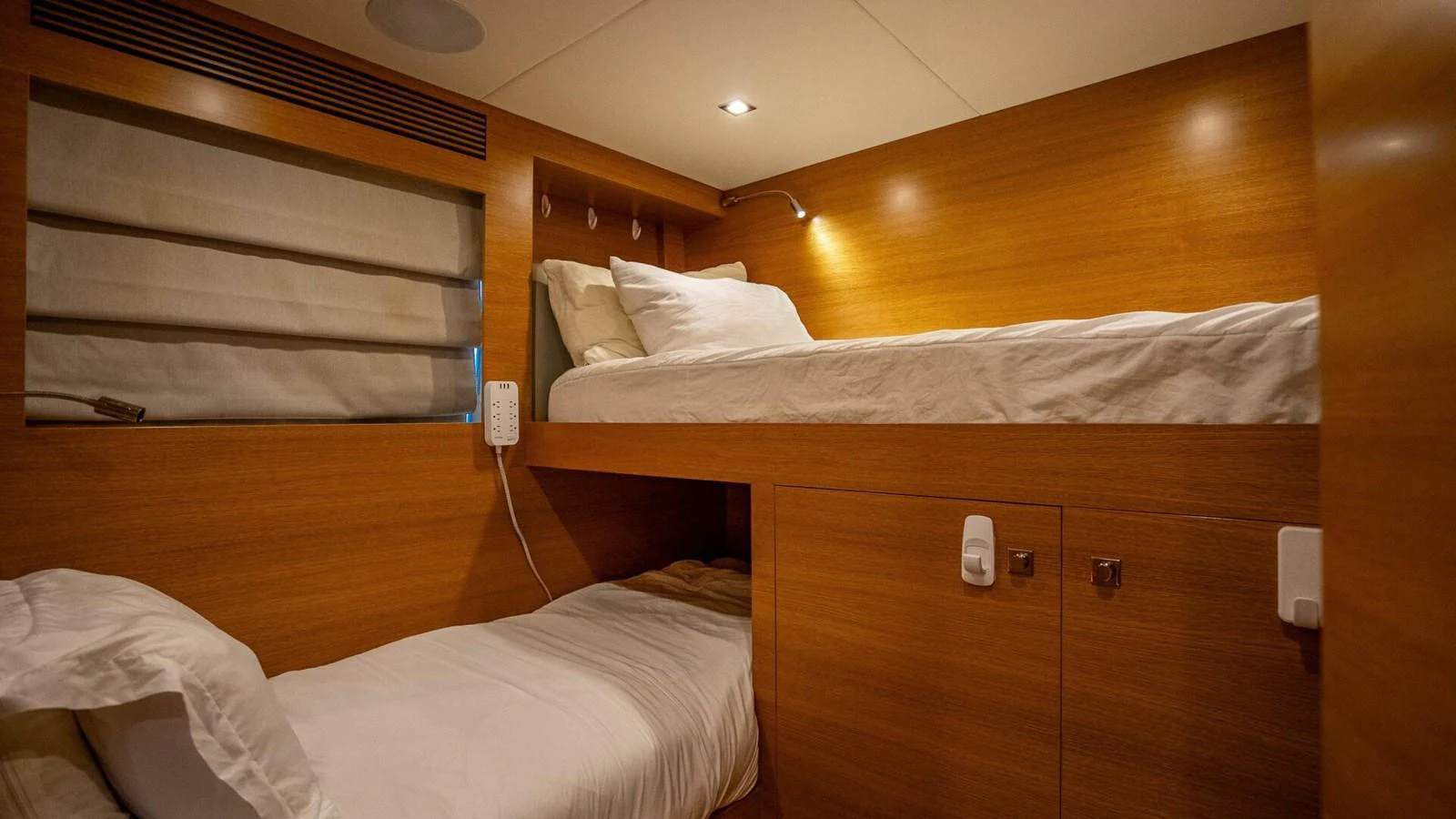 A cozy cabin with wooden paneling and bunk beds, perfect for a restful night's sleep. aboard SHORT STORY Yacht for Sale