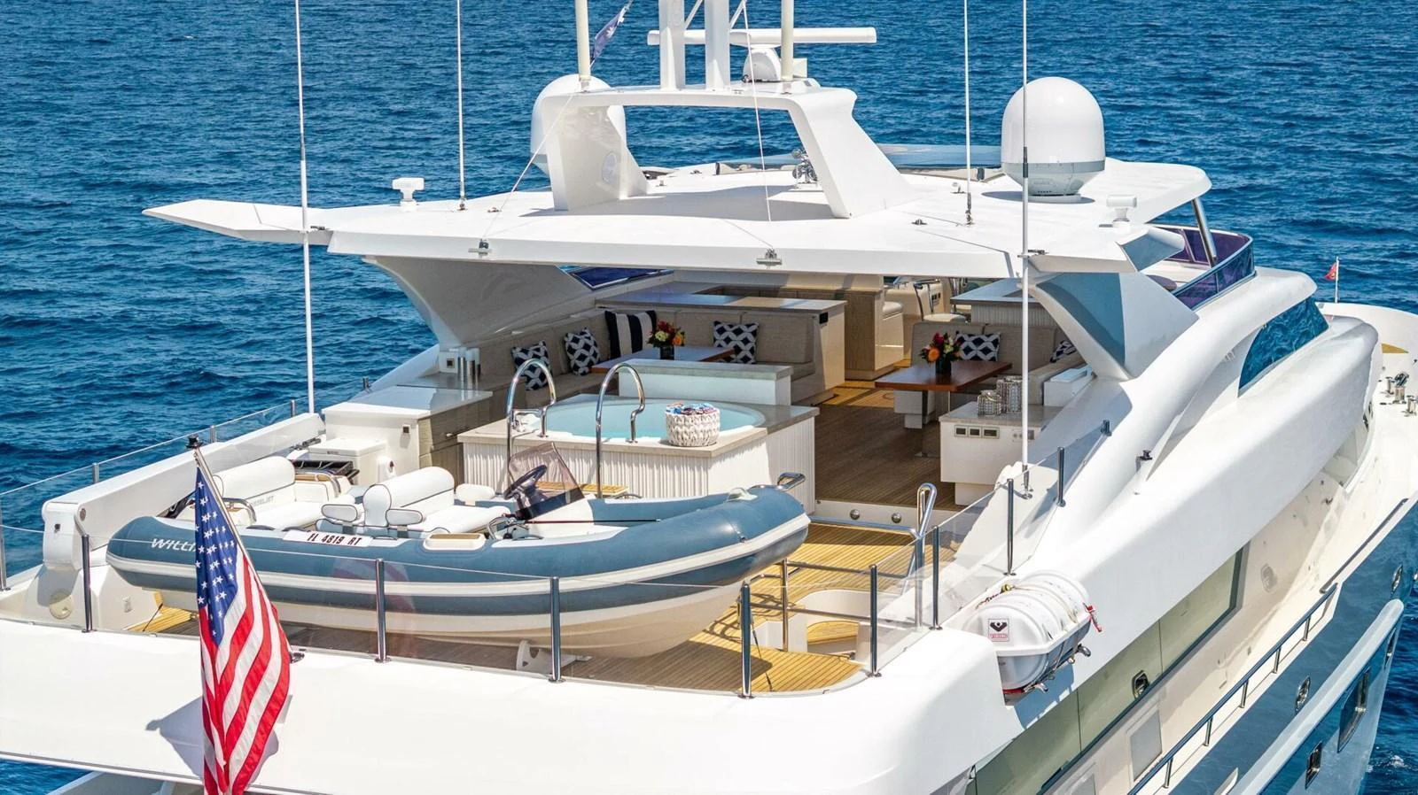 The yacht's sundeck features a luxurious lounging area with a jacuzzi and tender, perfect for relaxation and entertainment. aboard SHORT STORY Yacht for Sale