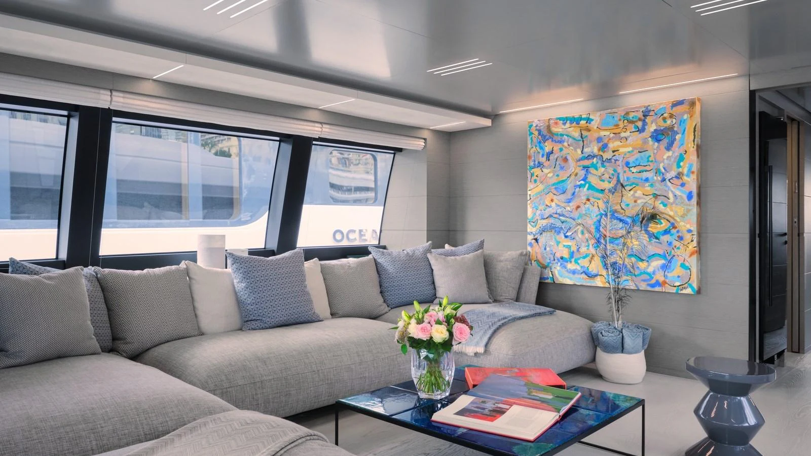 The salon features a spacious and modern seating area with contemporary decor and large windows. aboard BIZMAN Yacht for Sale