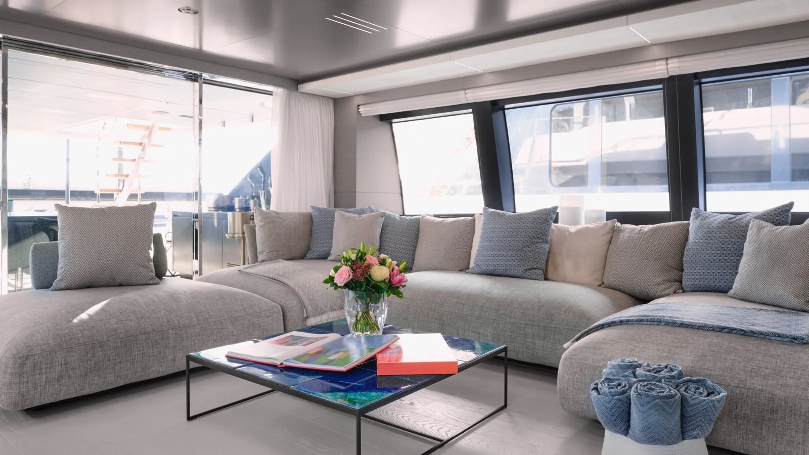 The salon features a spacious and elegantly furnished seating area with large windows offering ample natural light. aboard BIZMAN Yacht for Sale