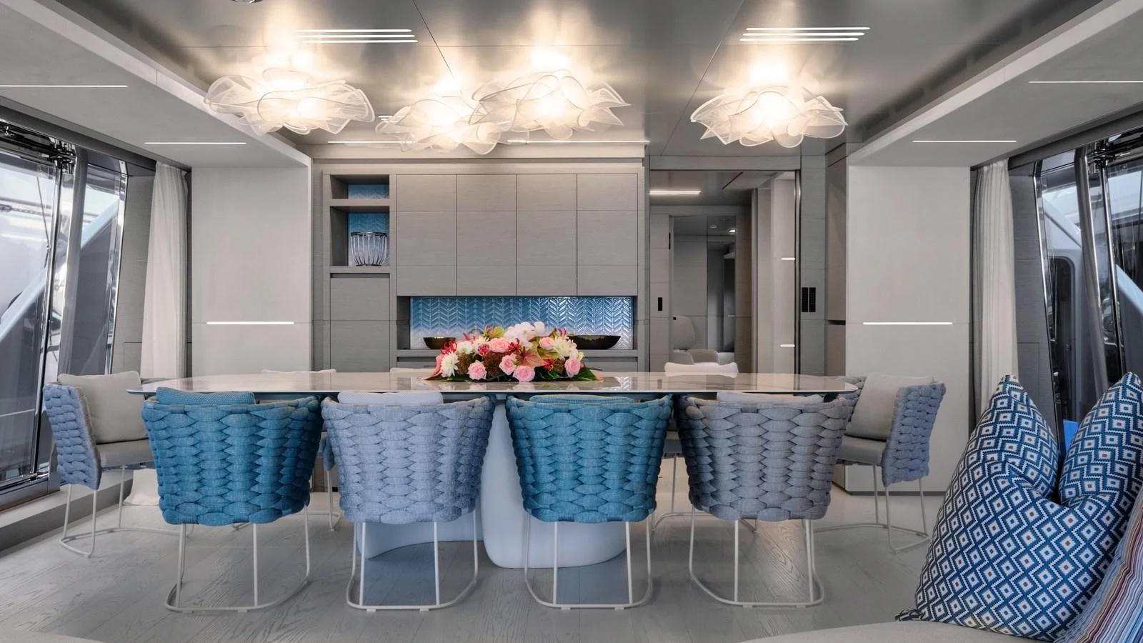The yacht's dining area features a modern design with elegant lighting and comfortable seating. aboard BIZMAN Yacht for Sale