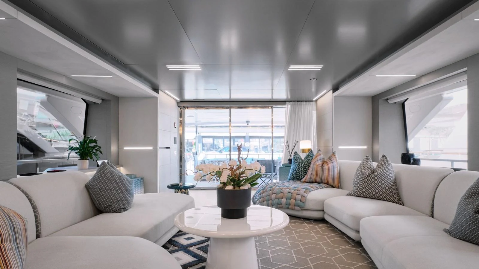 The salon features plush seating and a modern, elegant design with ample natural light. aboard BIZMAN Yacht for Sale