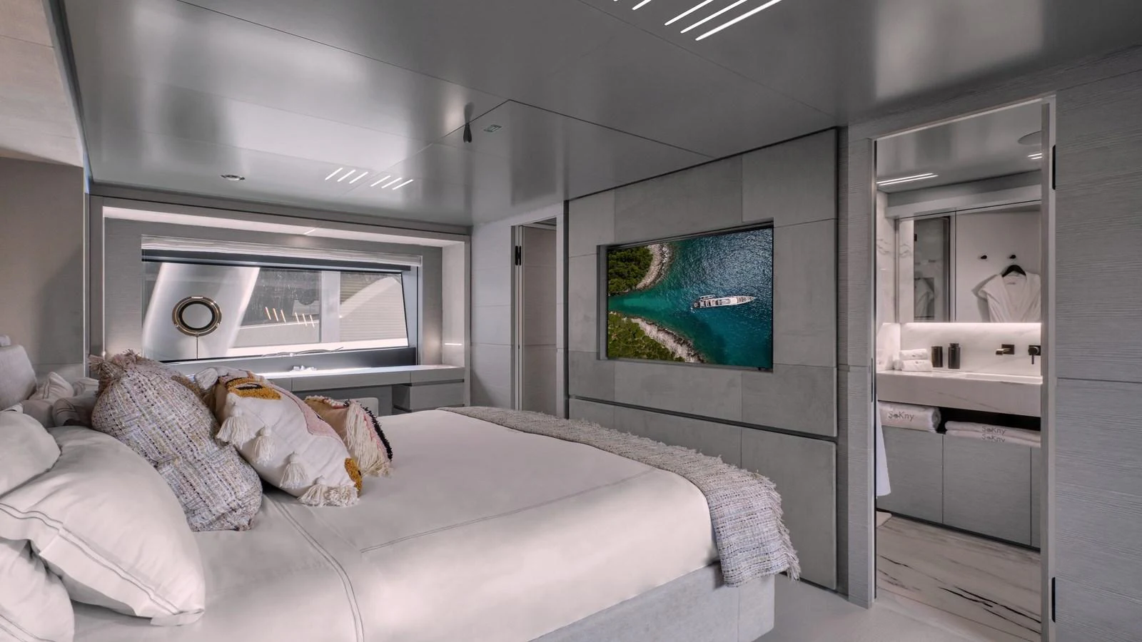 A luxurious stateroom featuring a large bed, modern decor, and a flat-screen TV. aboard BIZMAN Yacht for Sale