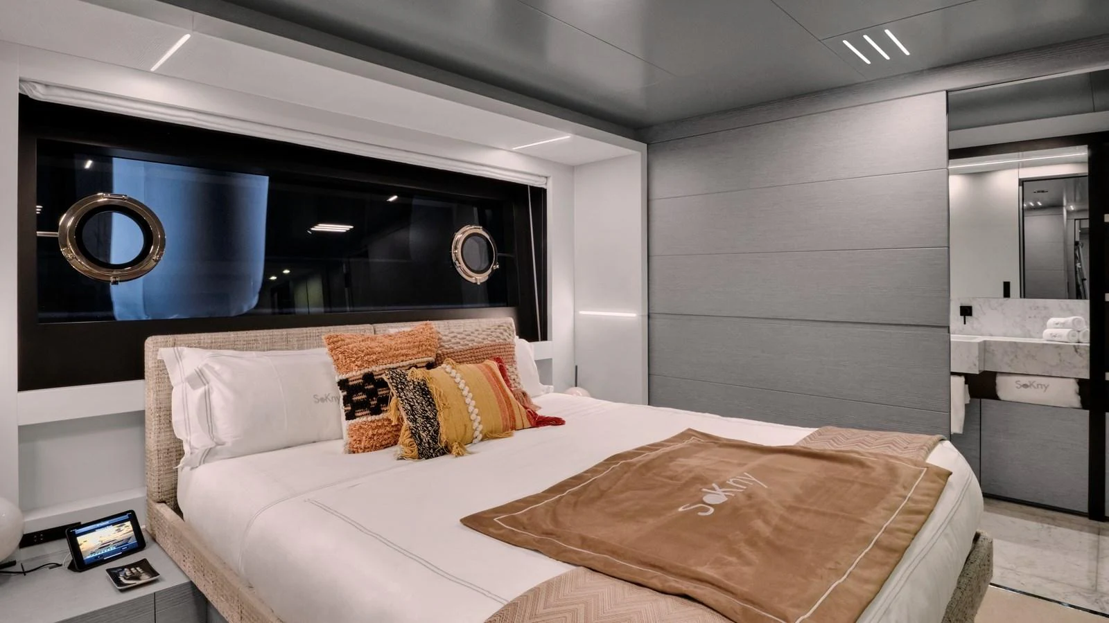 The stateroom features a luxurious bed with elegant bedding and modern decor. aboard BIZMAN Yacht for Sale