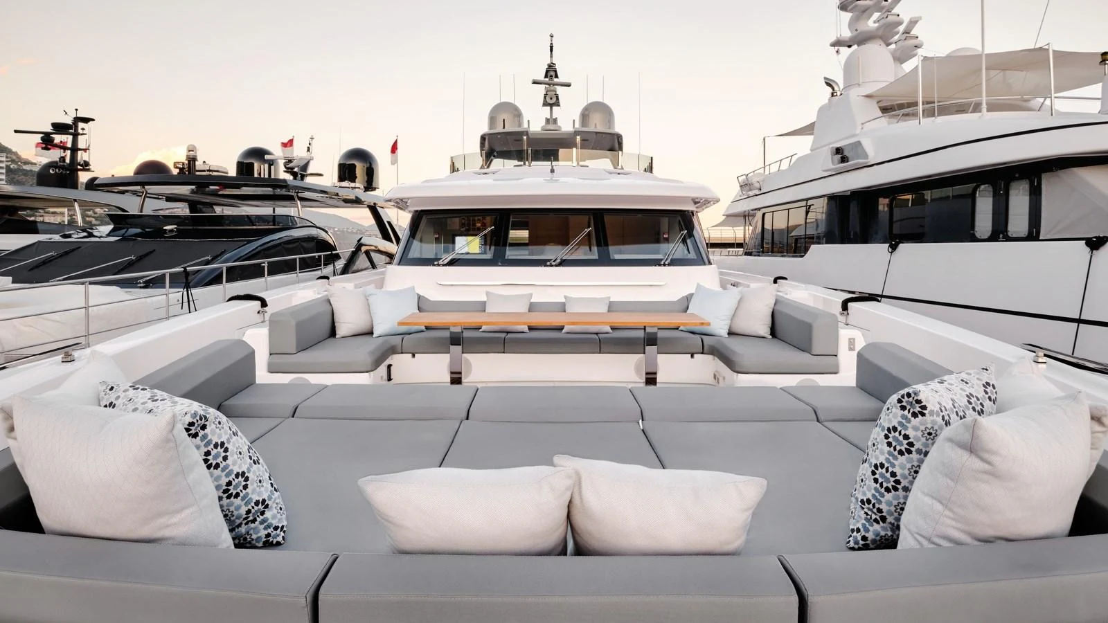 The yacht's aft deck features a spacious and elegant seating area with plush cushions and a central table, perfect for relaxation and socializing. aboard BIZMAN Yacht for Sale
