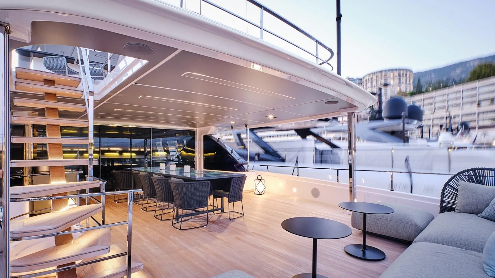 The aft deck offers a spacious and elegant outdoor dining and lounging area with modern furnishings. aboard BIZMAN Yacht for Sale