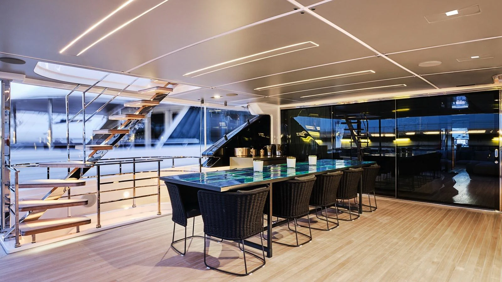 The yacht's dining area features a modern table with seating for eight, complemented by sleek design elements and ambient lighting. aboard BIZMAN Yacht for Sale