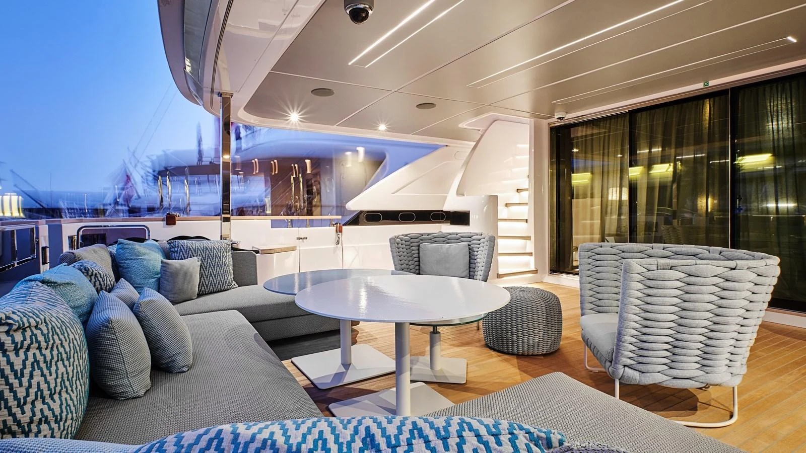 The aft deck features a stylish seating area with modern furnishings and ambient lighting. aboard BIZMAN Yacht for Sale
