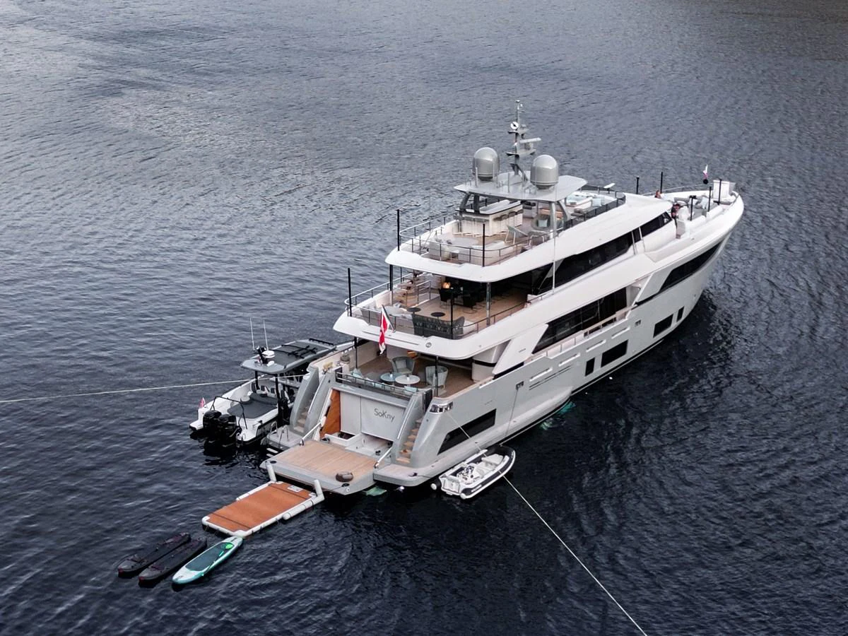 A luxurious yacht is anchored on calm waters, showcasing its elegant design and spacious decks. aboard BIZMAN Yacht for Sale