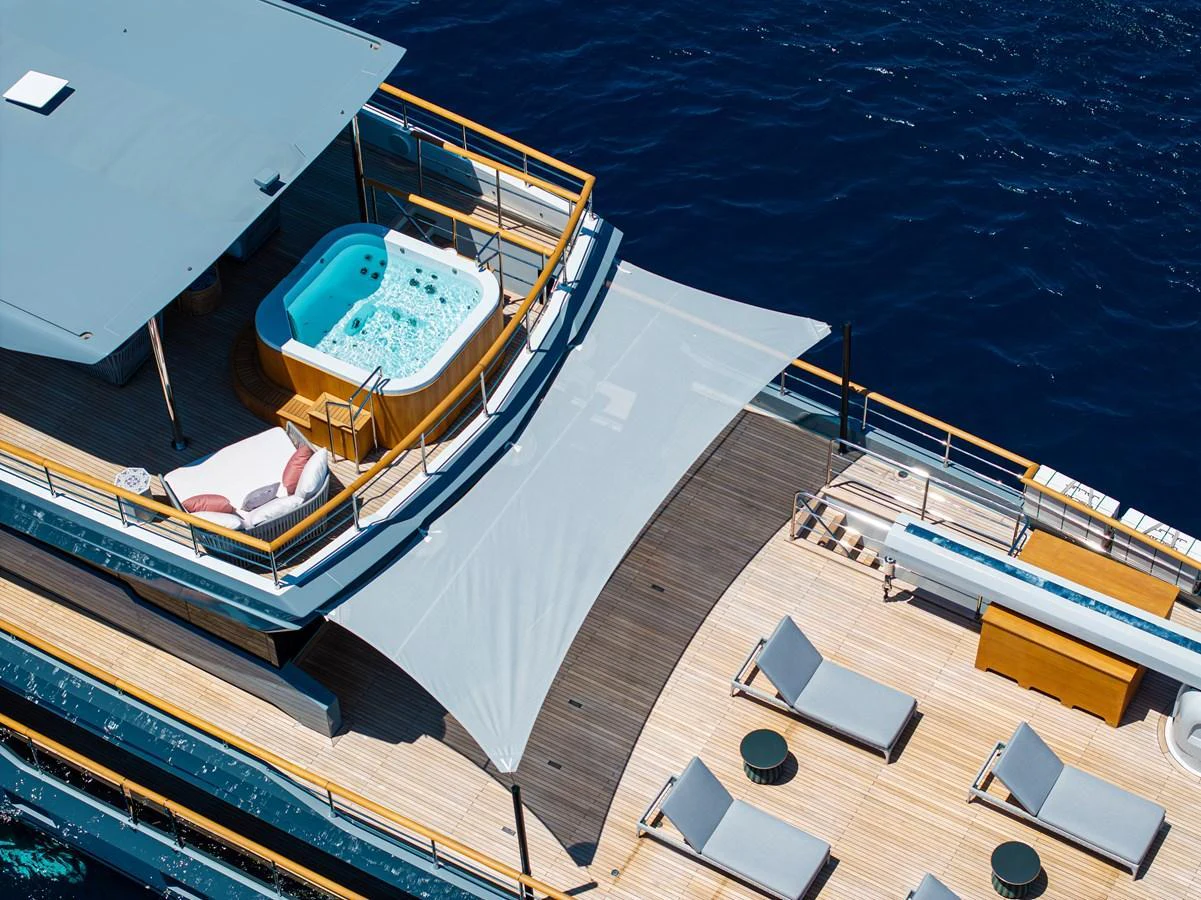 The sundeck features a luxurious hot tub and ample lounging space with sunbeds, perfect for relaxation. aboard OSCAR Yacht for Sale