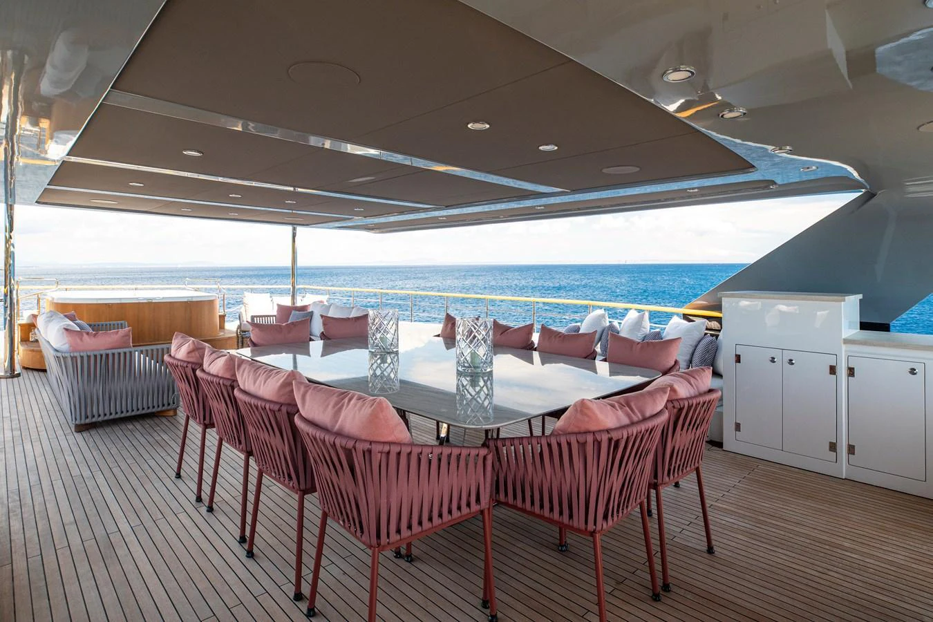 The aft deck features a spacious outdoor dining area with comfortable seating and ocean views. aboard OSCAR Yacht for Sale