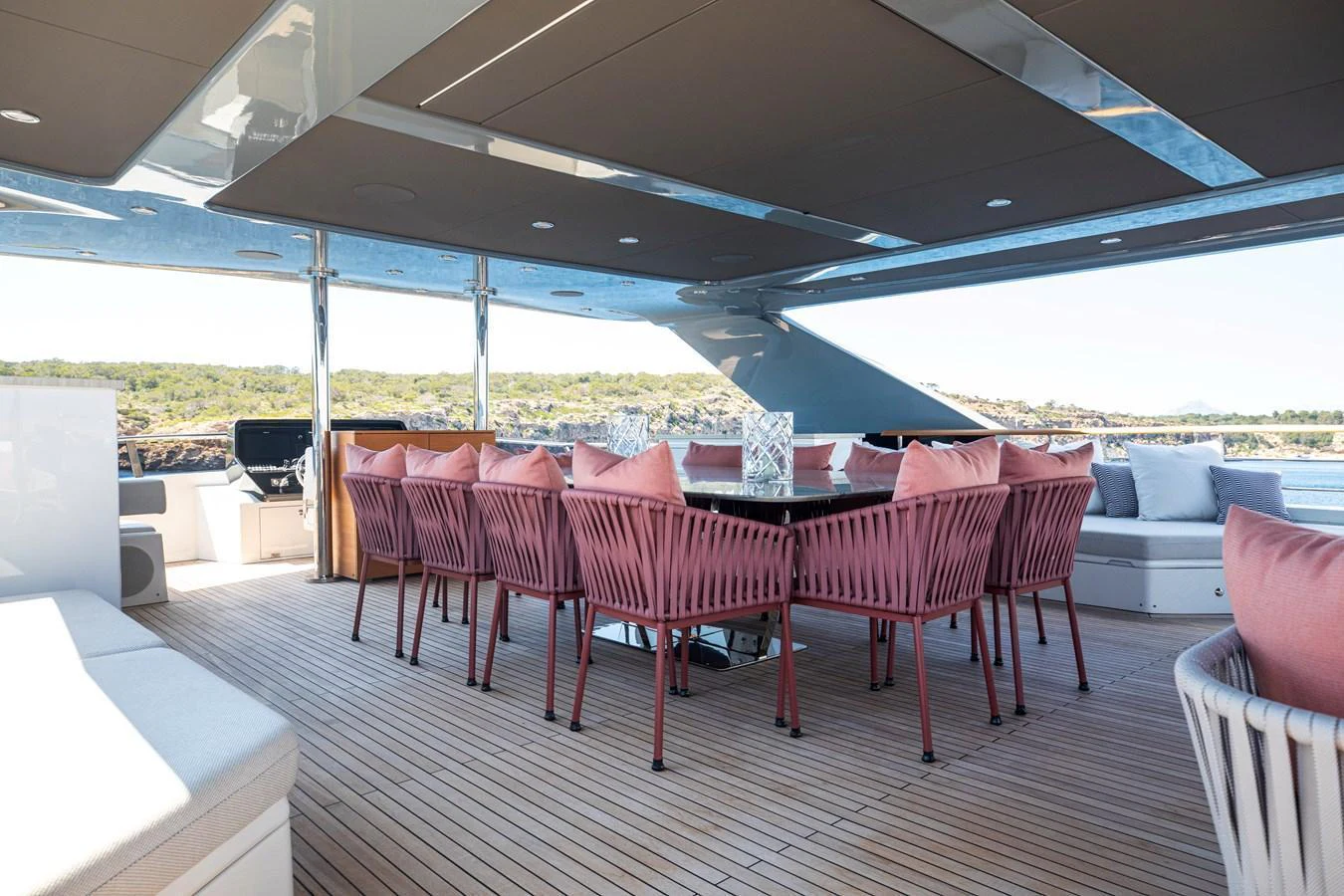 The aft deck features a spacious dining area with stylish seating and panoramic views. aboard OSCAR Yacht for Sale