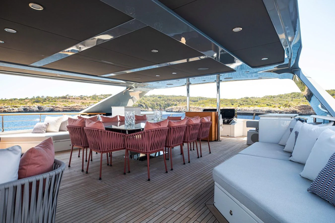 The aft deck features a spacious outdoor dining area with comfortable seating and scenic views. aboard OSCAR Yacht for Sale