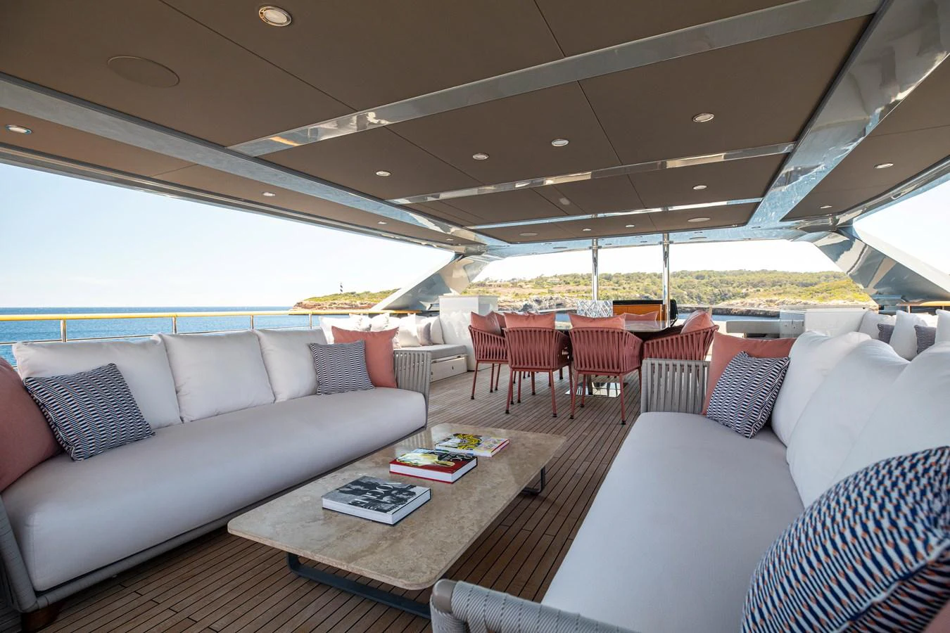 The spacious aft deck features luxurious seating and a dining area with stunning ocean views. aboard OSCAR Yacht for Sale