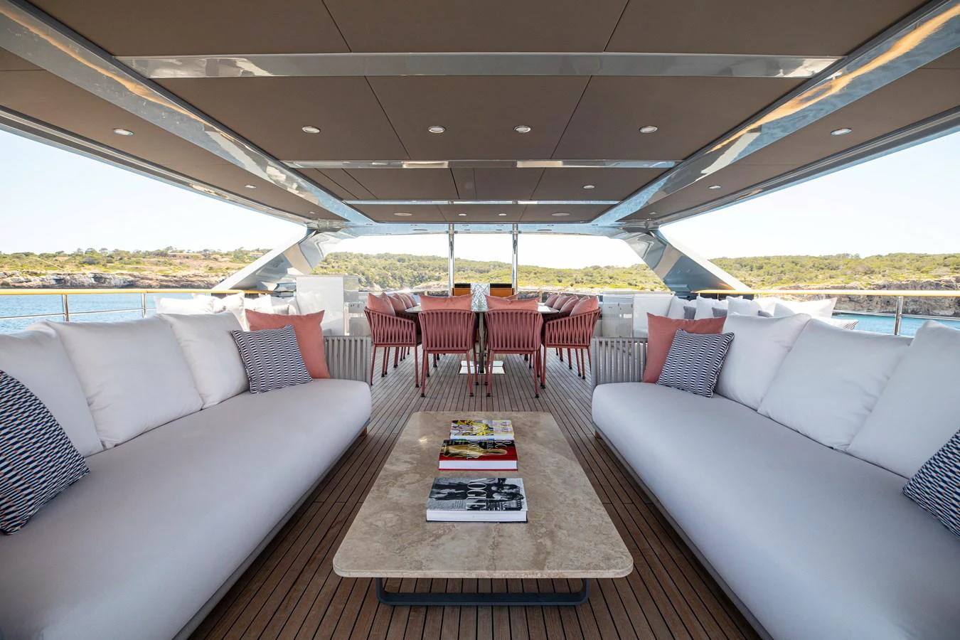 The aft deck features spacious seating with a central table, perfect for relaxation and socializing. aboard OSCAR Yacht for Sale