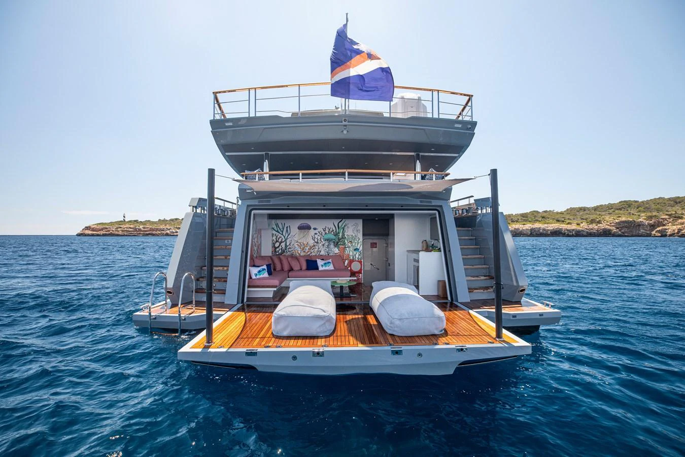The yacht's aft deck features a spacious lounging area with comfortable seating and direct access to the water. aboard OSCAR Yacht for Sale