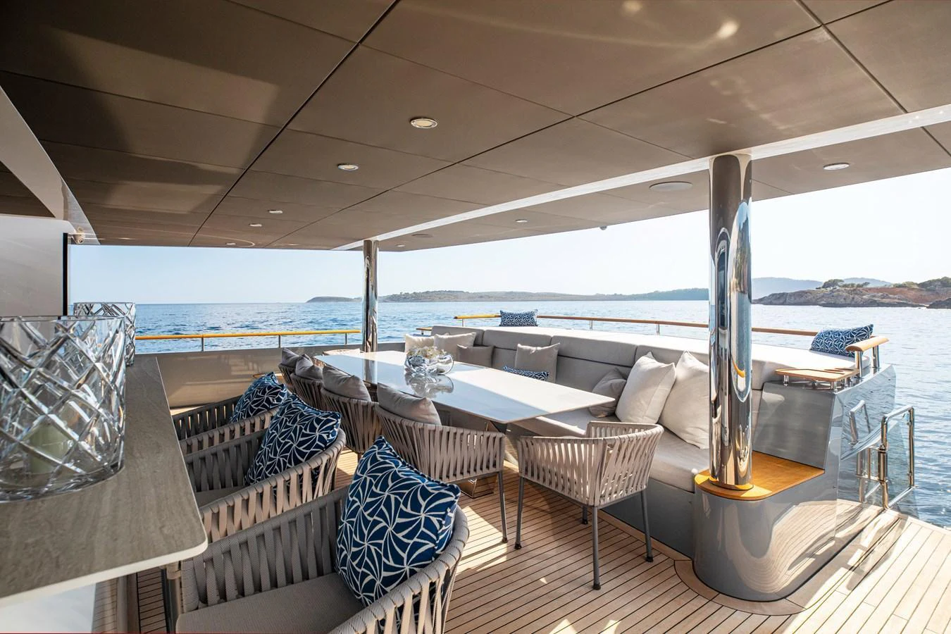 The aft deck offers a spacious and elegant outdoor seating area with stunning ocean views. aboard OSCAR Yacht for Sale