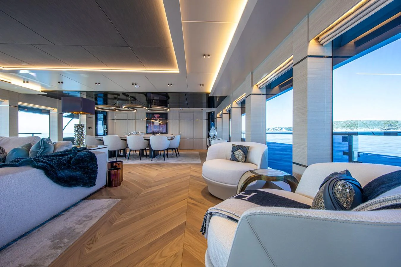 The yacht's salon features luxurious seating, modern decor, and expansive windows offering stunning sea views. aboard OSCAR Yacht for Sale