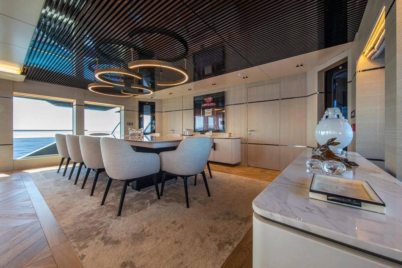 The yacht's dining area features a modern design with elegant furnishings and a stunning view of the sea. aboard OSCAR Yacht for Sale