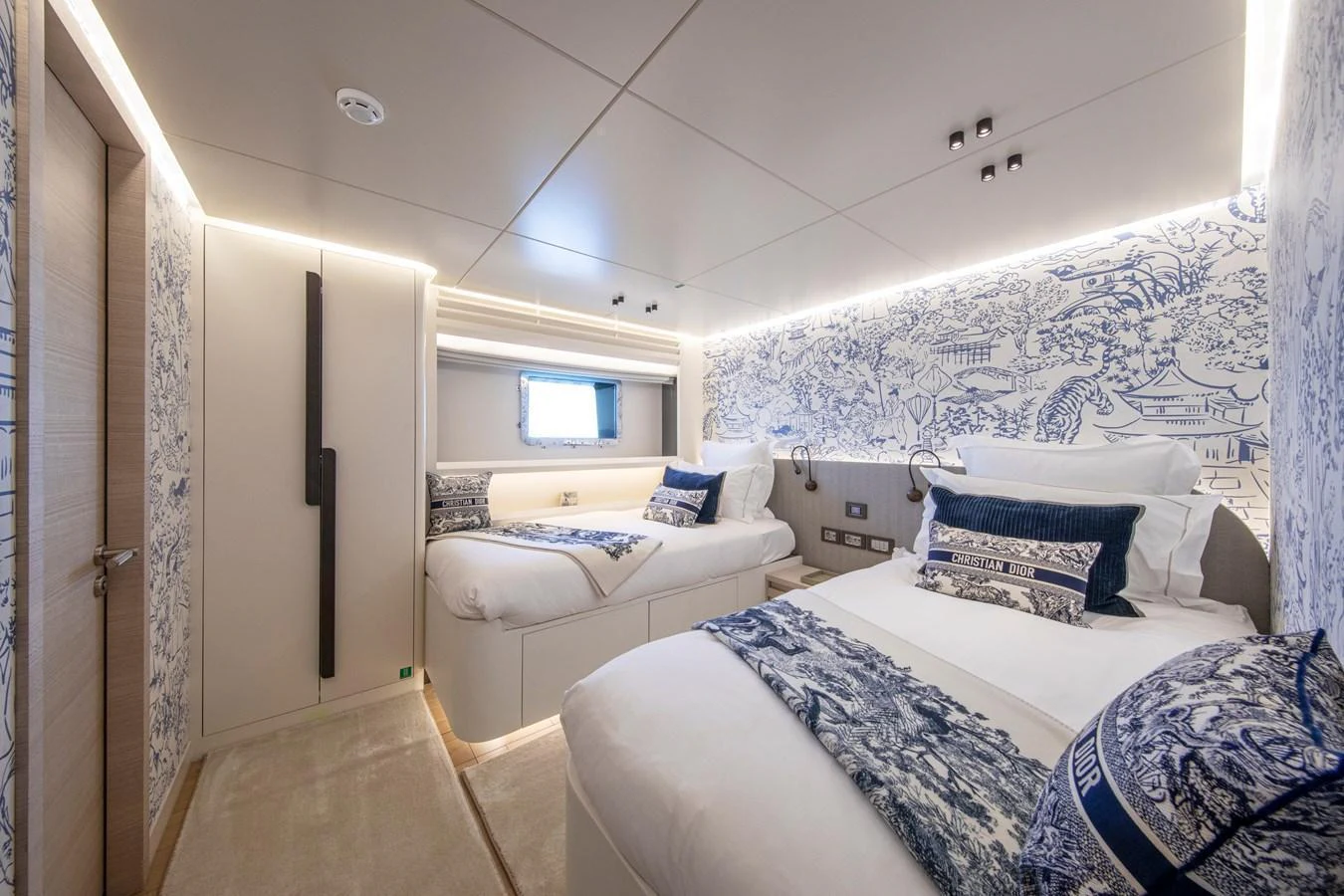 The guest stateroom features twin beds with elegant bedding and sophisticated wall decor. aboard OSCAR Yacht for Sale