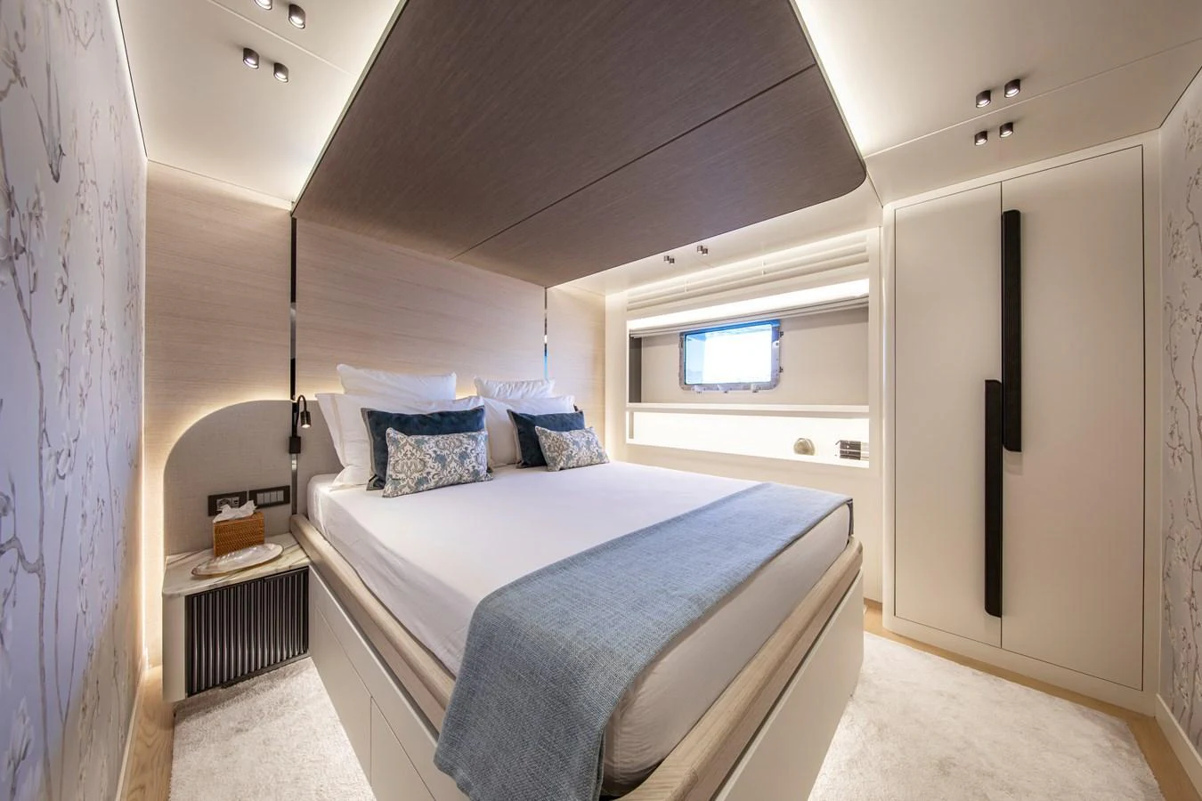 The stateroom features a luxurious bed with elegant bedding and modern lighting. aboard OSCAR Yacht for Sale