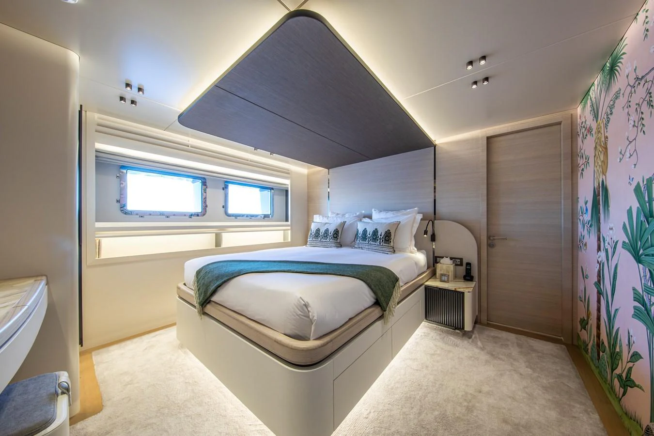 A luxurious stateroom featuring a large bed, modern decor, and ample natural light. aboard OSCAR Yacht for Sale