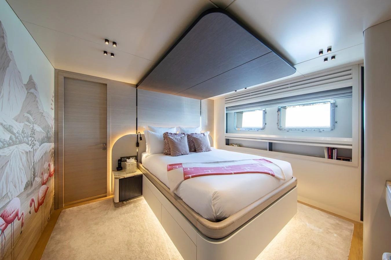 A luxurious stateroom featuring a large bed, modern decor, and ample natural light from the windows. aboard OSCAR Yacht for Sale